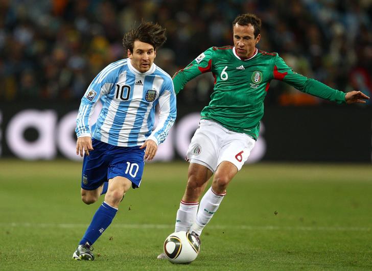 JOHANNESBURG, SOUTH AFRICA - JUNE 27:  Lionel Messi of Argentina goes past Gerardo Torrado of Mexico during the 2010 FIFA World Cup South Africa Round of Sixteen match between Argentina and Mexico at Soccer City Stadium on June 27, 2010 in Johannesburg, South Africa.  (Photo by Richard Heathcote/Getty Images)
