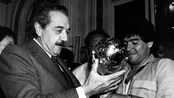Diego Maradona (R), captain for the 1986 World Cup-winning soccer squad, hands the World Cup to then Argentine President Raul Alfonsin during a welcome ceremony at the government house in Buenos Aires in this file photo taken June 30, 1986. Alfonsin, 82, who guided Argentina's return to democracy in the 1980s after seven years of brutal military rule but failed to stave off a deep economic crisis, died on March 31, 2009, of lung cancer. Alfonsin was president from 1983 to 1989 and won international admiration for putting on trial and jailing the former military leaders who tortured and killed thousands of suspected leftists in a vicious 